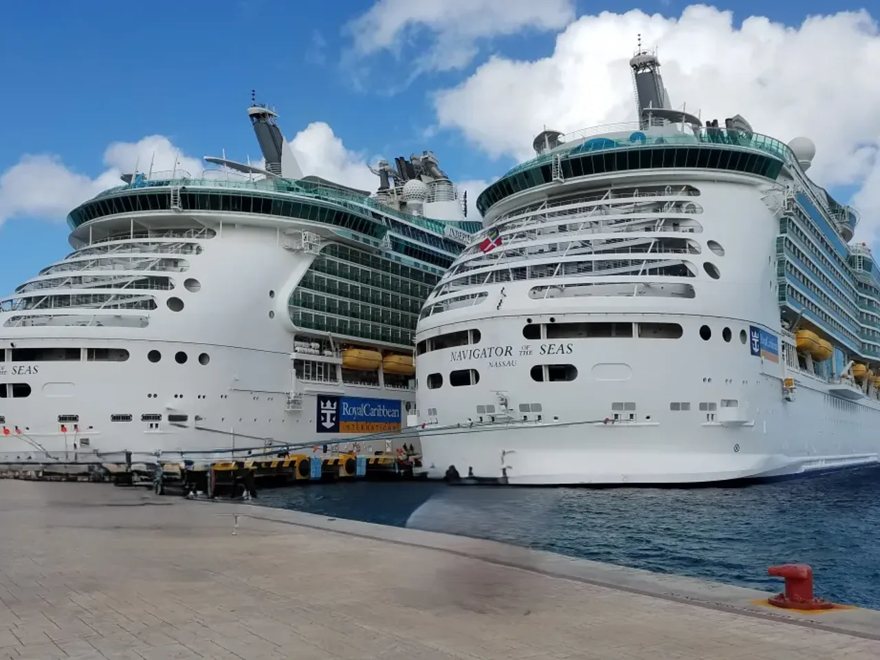 Two cruise ships docked in port — ocean and river cruise vacations planned by Suncoast Travel